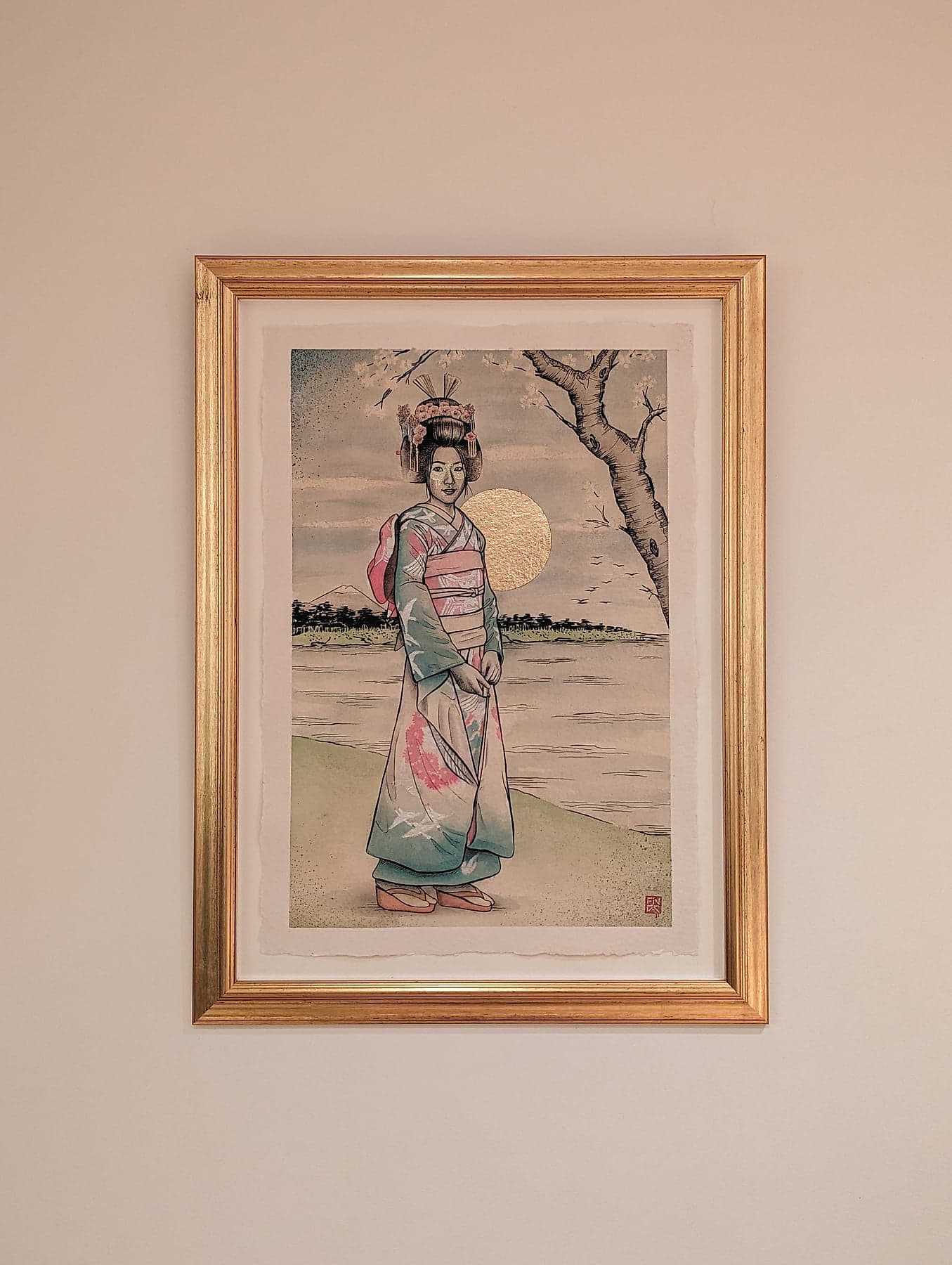 Fin DAC’s ukiyo-e style portrait of Rieko framed in gold on a wall, the deckle edge of the paper showing against the mount