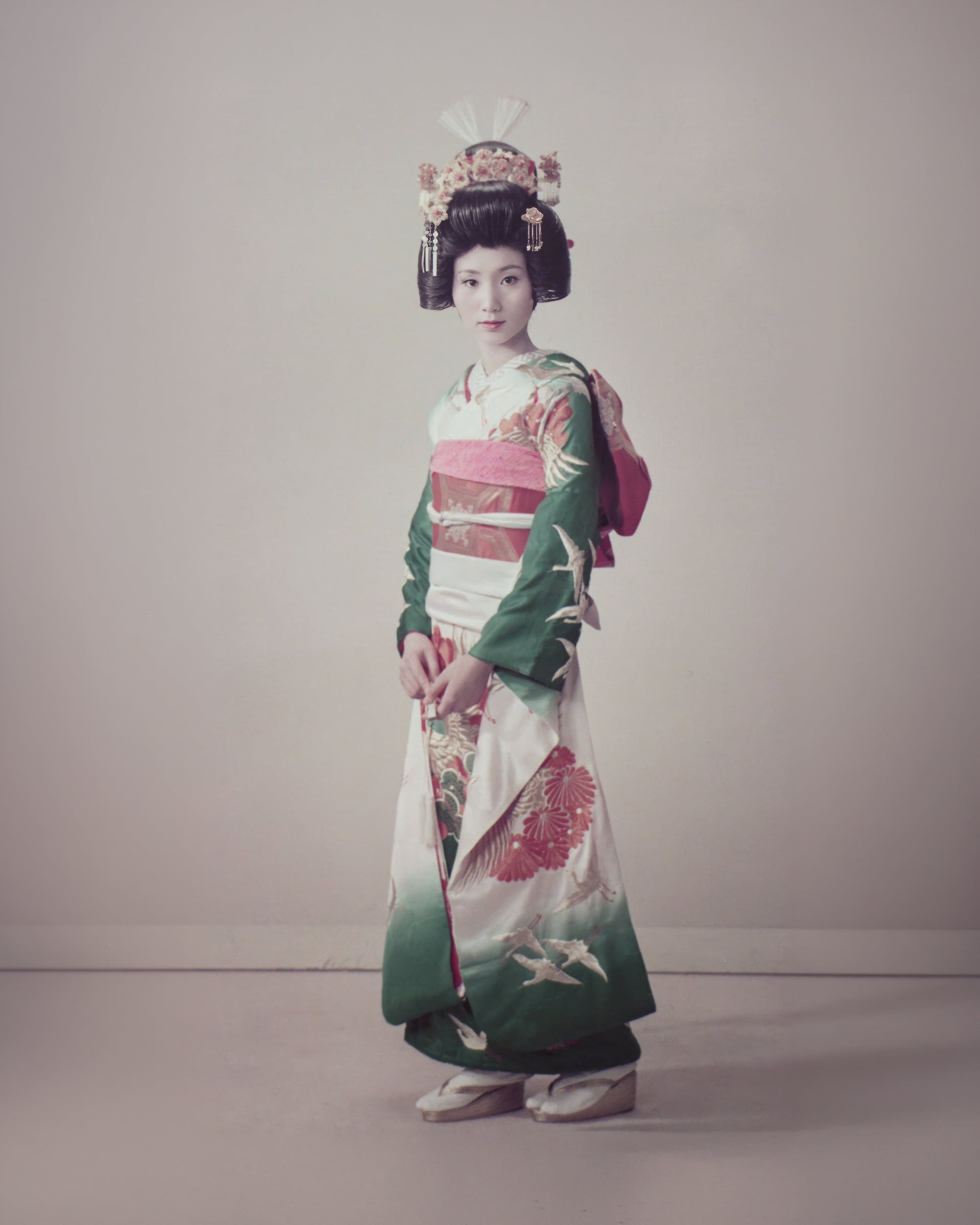 Rieko’s mother Mitsuko on her wedding day in 1970s Japan, wearing a green kimono embroidered with white cranes