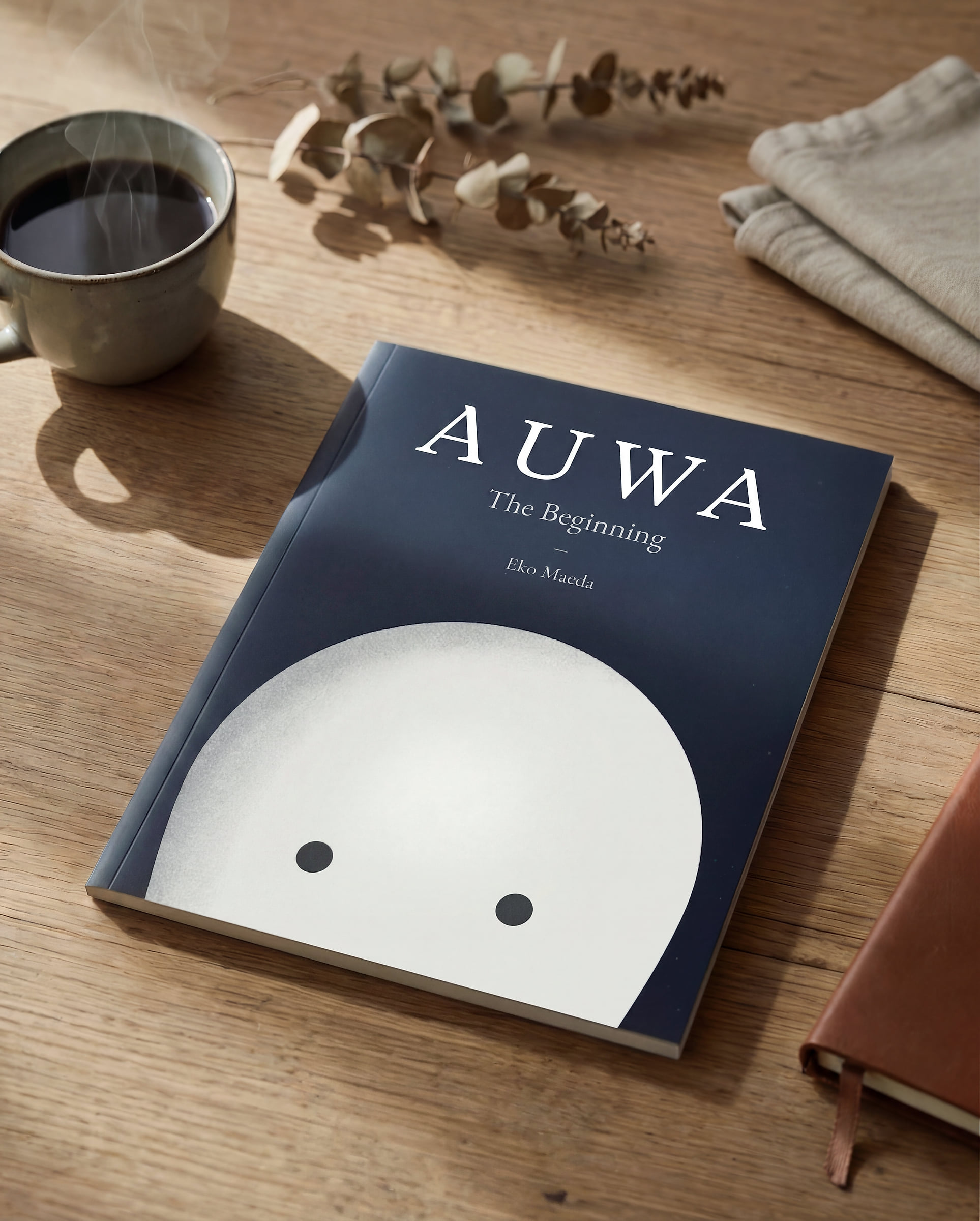 The first Auwa book on a wooden table